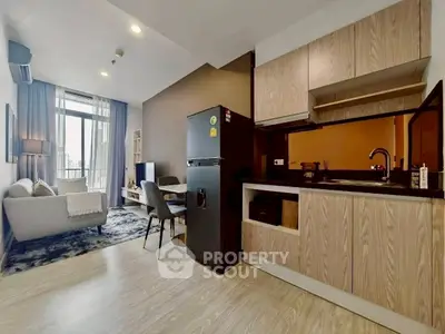 Modern open-plan living room and kitchen with stylish decor and natural light