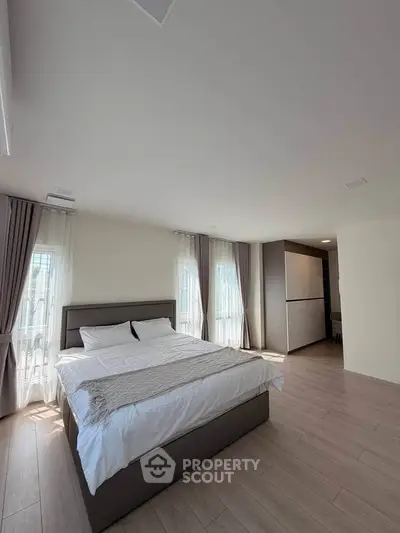 Spacious bedroom with modern decor and natural light