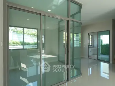 Spacious modern living area with glass sliding doors and abundant natural light