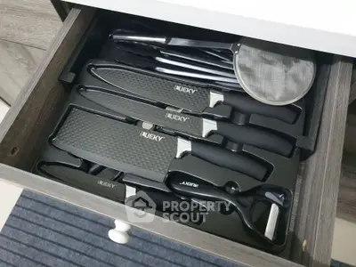 Modern kitchen drawer with sleek knife set and utensils