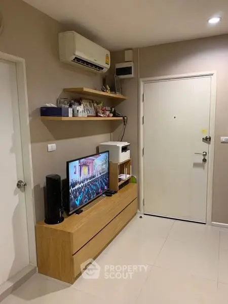 Modern living room with sleek TV setup and stylish shelving