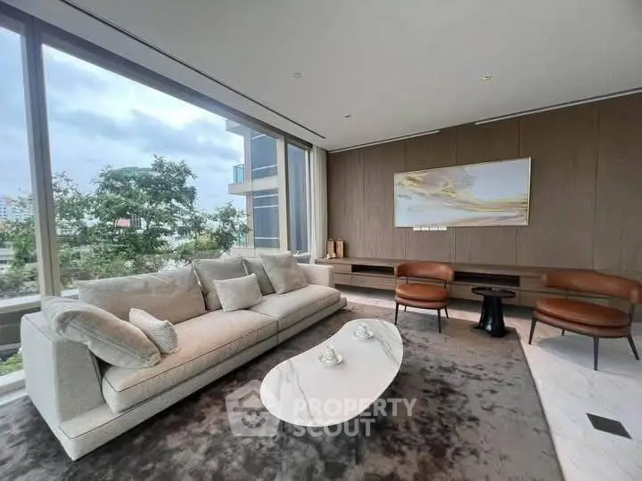 Luxurious living room with modern furniture and large windows offering a stunning view.