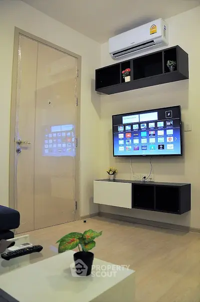 Modern living room with wall-mounted TV and air conditioning unit