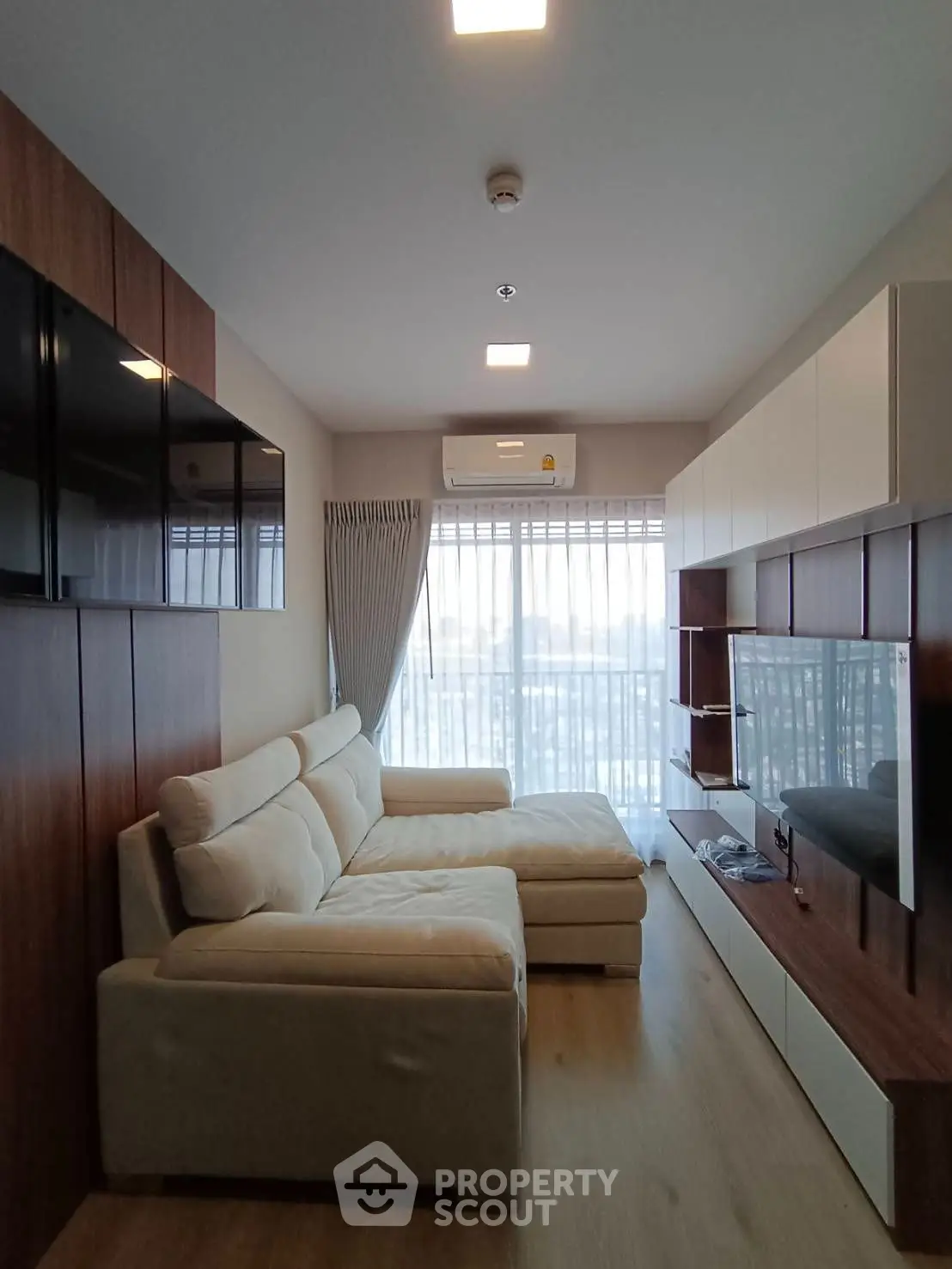 Modern living room with stylish furniture and large windows offering natural light.