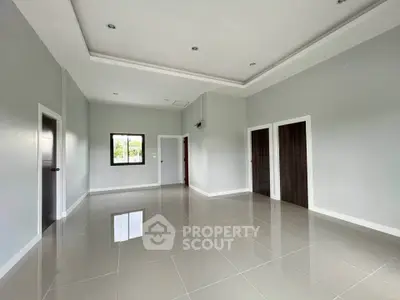 Spacious empty room with glossy tiled floor and modern ceiling design