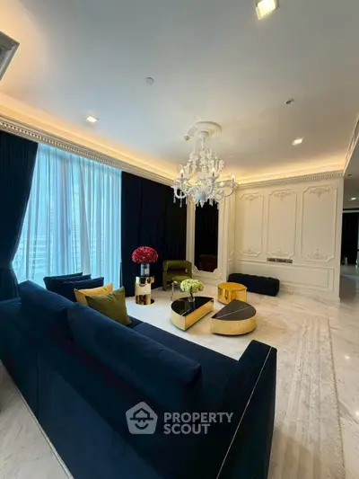 Luxurious living room with elegant chandelier and plush seating in a sophisticated interior design.