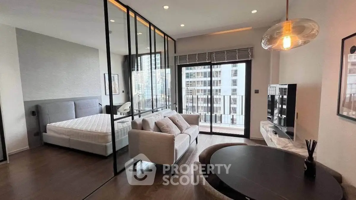 Modern open-plan living room with glass partition and city view balcony
