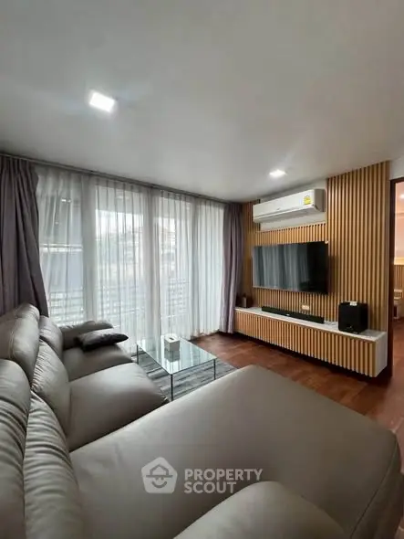 Modern living room with stylish decor and large windows for natural light