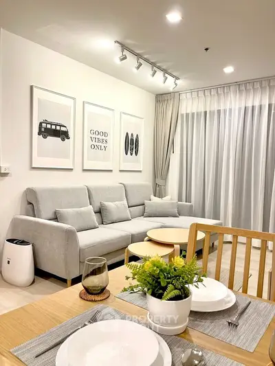 Modern living room with stylish decor and cozy ambiance, featuring a comfortable sofa and elegant dining area.