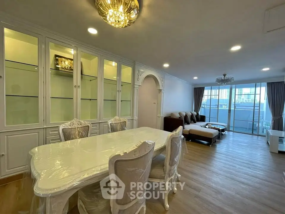 Luxurious living room with elegant dining area and spacious seating, featuring a stunning city view.