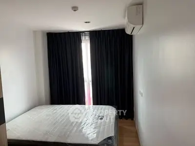 Cozy bedroom with natural light and air conditioning, perfect for restful nights.