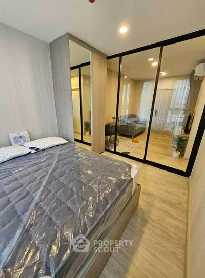 Modern bedroom with mirrored wardrobe and cozy decor