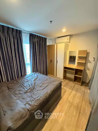 Modern bedroom with stylish furniture and natural light in a cozy apartment.