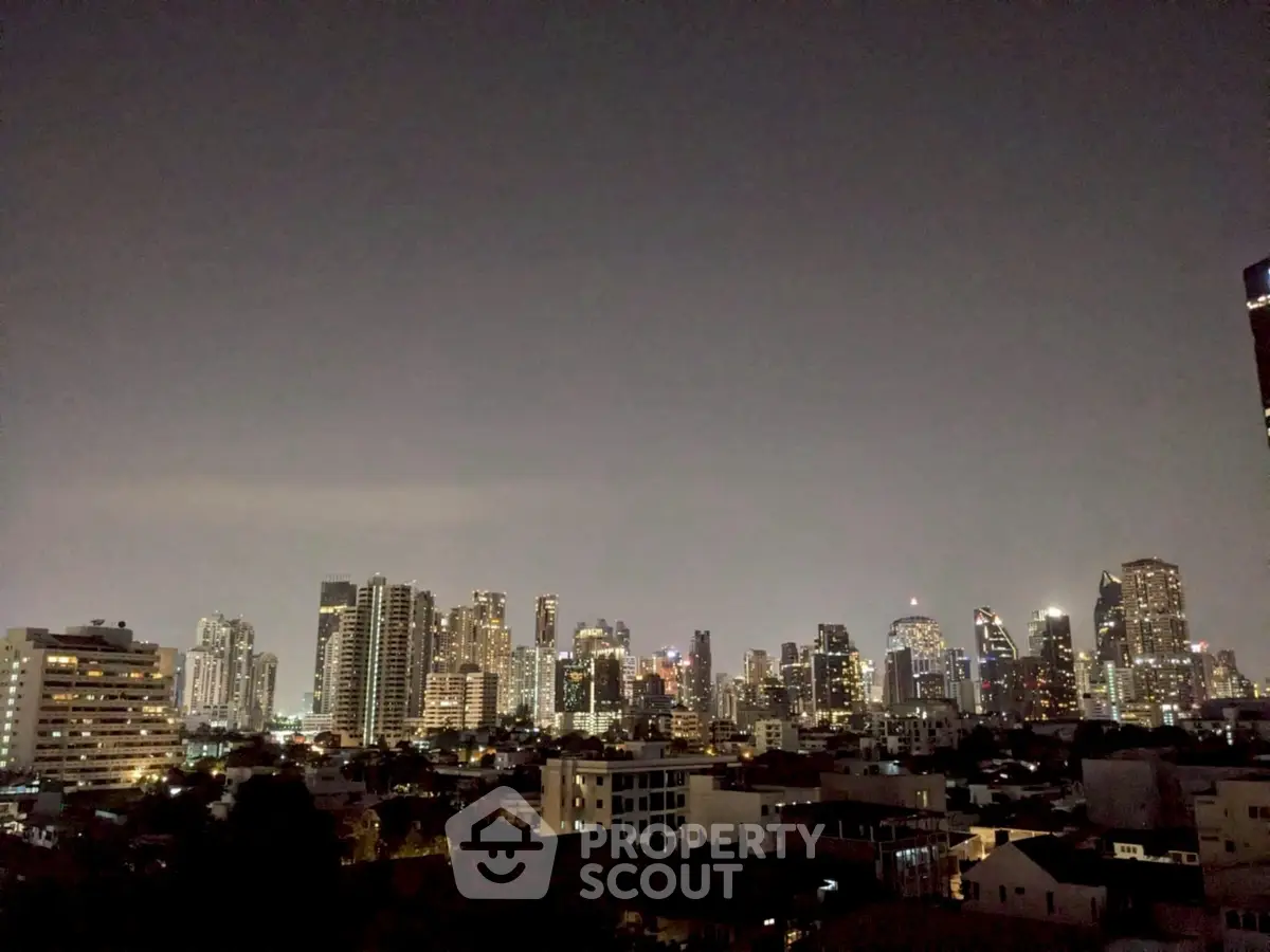 Stunning city skyline view at night with illuminated skyscrapers and urban landscape.