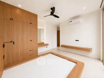 Modern minimalist bedroom with wooden accents and built-in storage