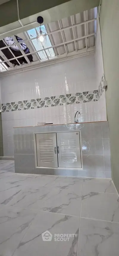 Modern kitchen with sleek tile design and compact layout