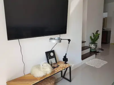 Modern living room with wall-mounted TV and stylish decor