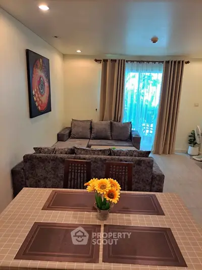 Cozy living room with stylish decor and natural light, perfect for relaxation and entertaining guests.