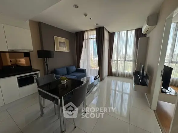 Modern living room with sleek kitchen and panoramic city view