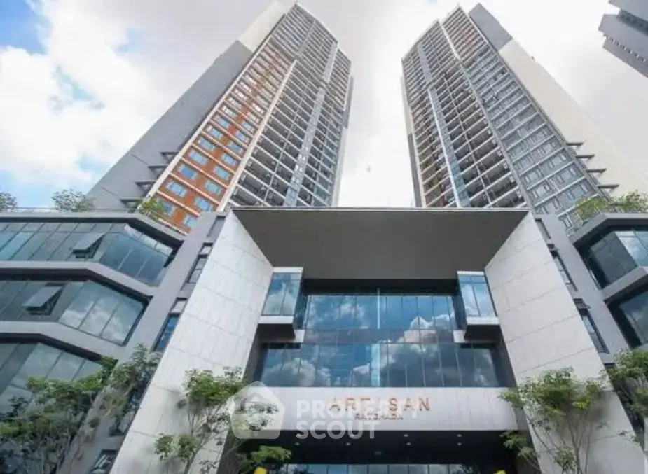 Stunning modern high-rise building with sleek architectural design and expansive glass windows.
