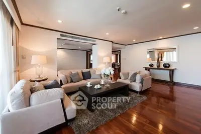 Spacious and elegant living room with modern decor and hardwood floors.