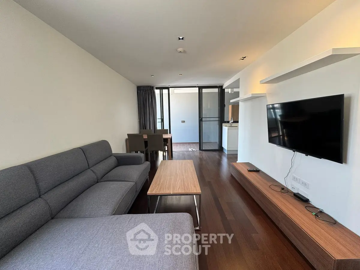 Modern living room with sleek furniture and open balcony view