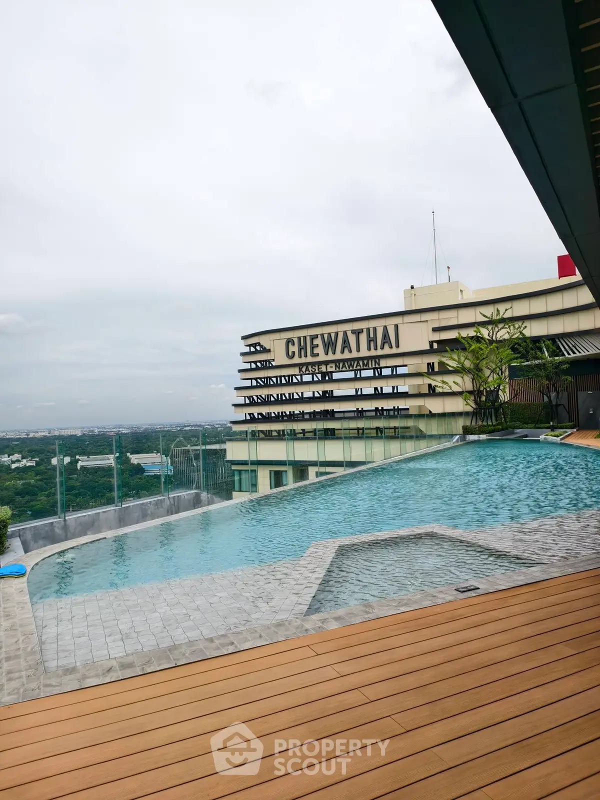 Luxurious rooftop infinity pool with stunning city view at Chewathai residence.