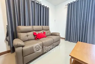 Cozy living room with plush sofa and modern decor, perfect for relaxation.