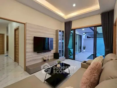 Modern living room with sleek design and poolside view, featuring elegant furniture and ambient lighting.