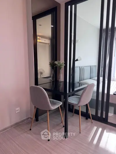 Modern bedroom with stylish glass partition and cozy dining area