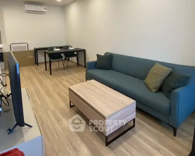 Modern living room with stylish furniture and wooden flooring
