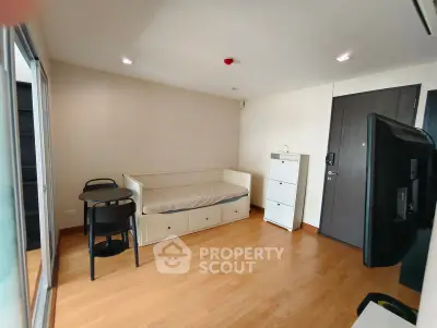 Cozy living room with wooden flooring, daybed, and modern furniture in a stylish apartment.