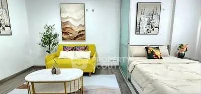 Modern studio apartment with stylish decor, featuring a cozy living area and comfortable bed.