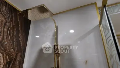 Luxurious modern bathroom with elegant rain shower and marble accents
