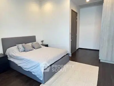 Modern bedroom with sleek design and cozy ambiance, featuring a comfortable bed and stylish decor.
