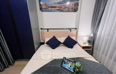 Cozy bedroom with modern decor and tablet on bed, perfect for relaxation.