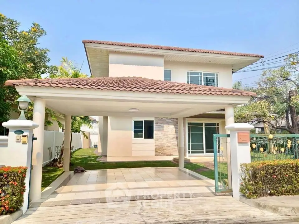 Charming two-story house with tiled roof and spacious driveway in a serene neighborhood.