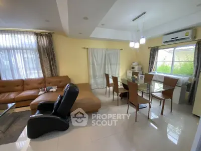 Spacious living room with modern furniture and large windows for natural light.