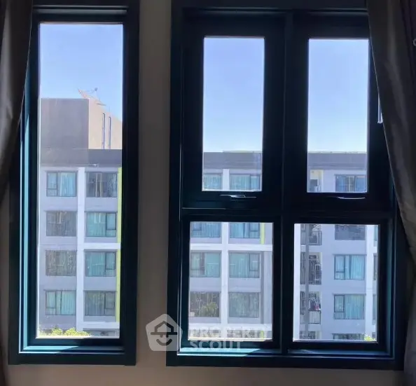 Modern apartment window view showcasing adjacent building architecture.