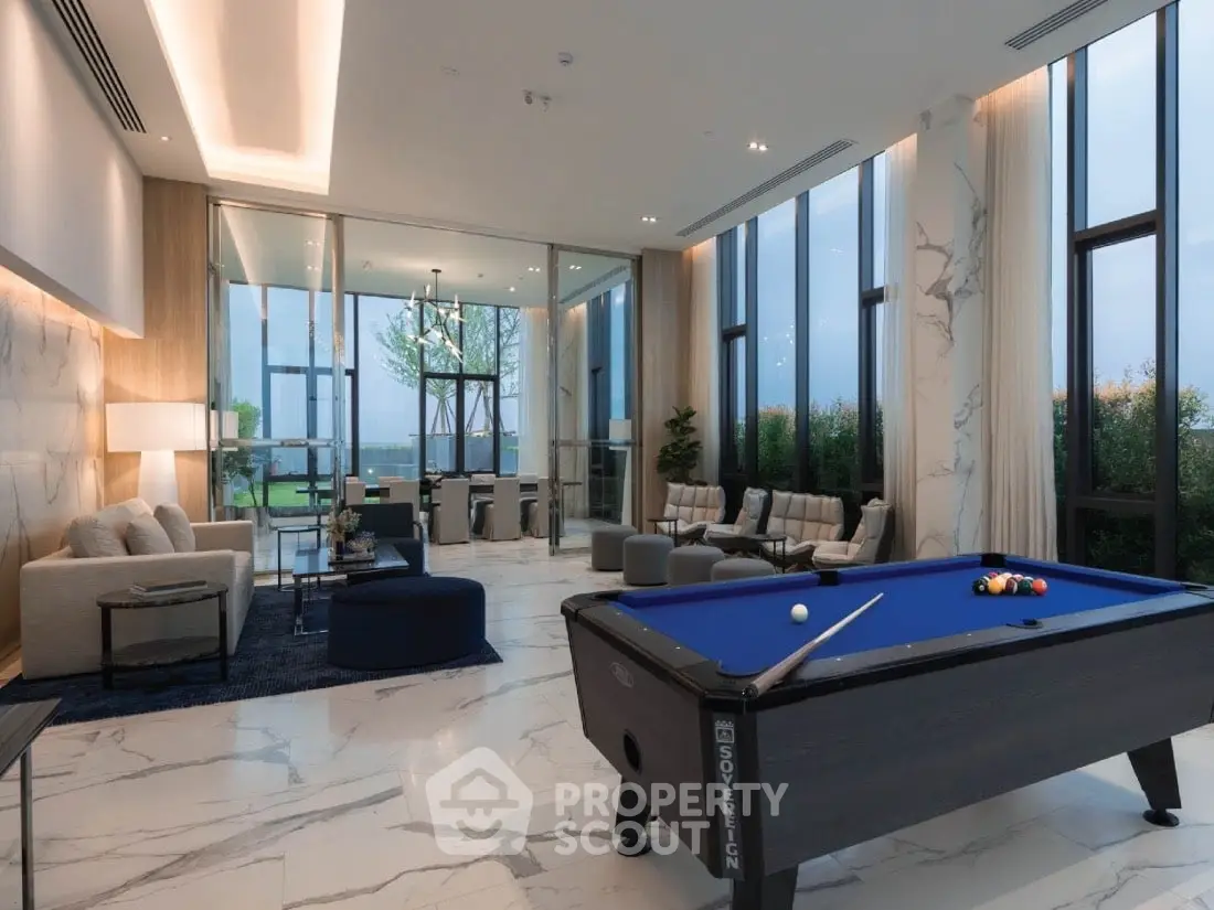 Luxurious modern living room with pool table and floor-to-ceiling windows