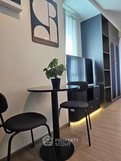 Modern living room with sleek black furniture and stylish decor