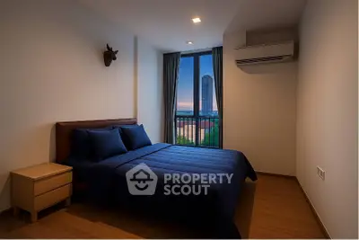 Modern bedroom with city view, featuring stylish decor and cozy ambiance, perfect for urban living.