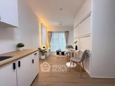 Modern open-plan kitchen and dining area with stylish decor and natural light.
