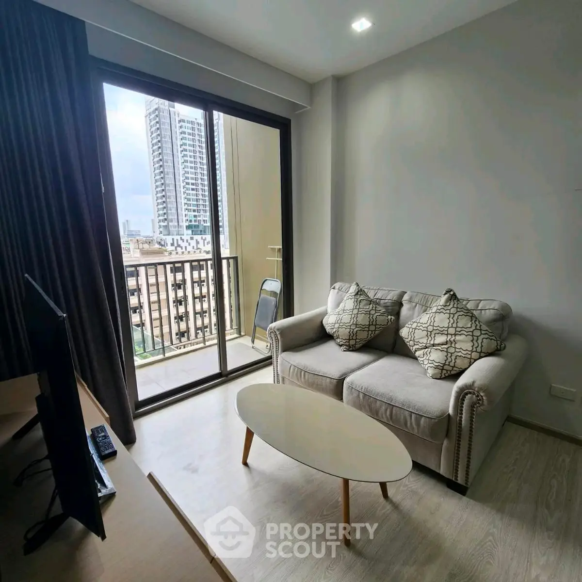 Modern living room with balcony view in high-rise apartment