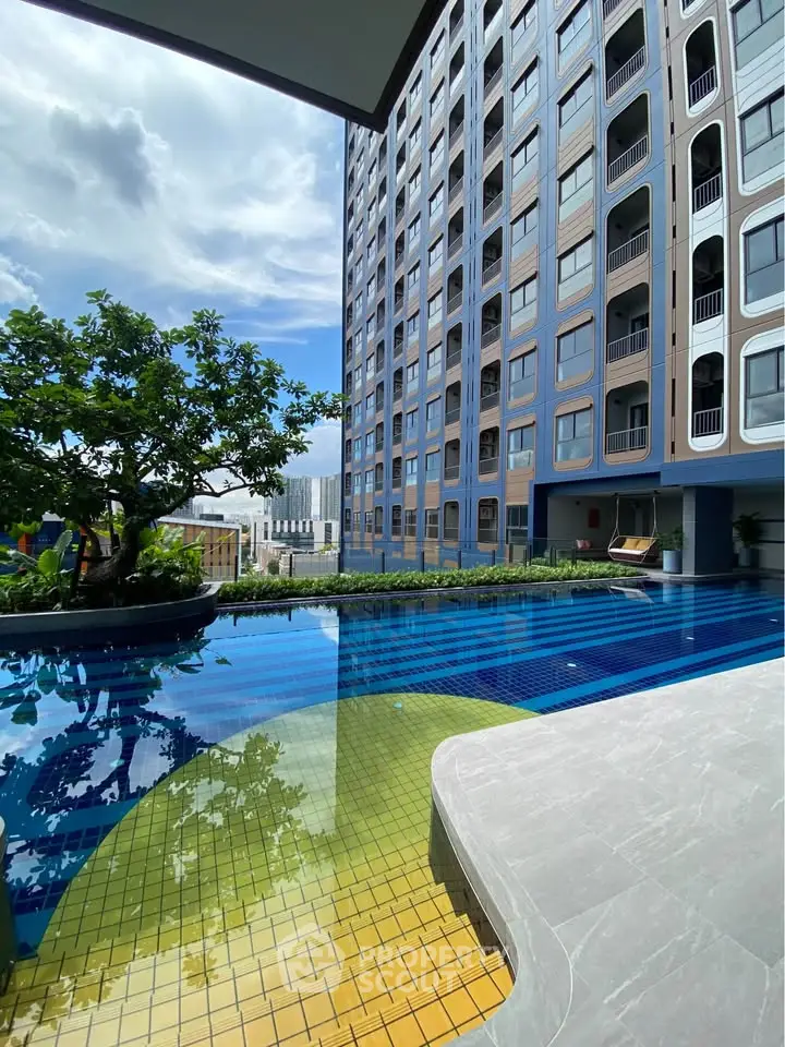 Luxurious high-rise building with stunning pool and city view, perfect for modern urban living.