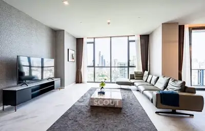 Spacious modern living room with large windows and city view