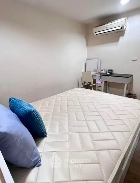 Cozy bedroom with air conditioning and study desk, perfect for comfort and productivity.