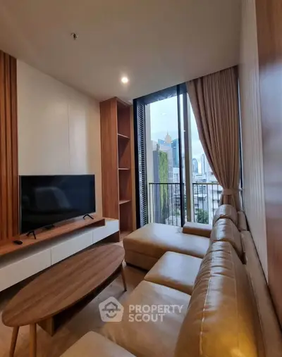 Modern living room with city view, featuring sleek furniture and floor-to-ceiling windows.