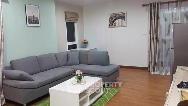 Modern living room with stylish gray sectional sofa and chic decor