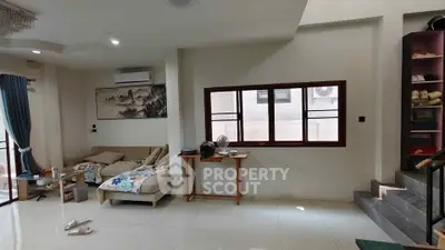 Spacious living room with modern decor and large windows for natural light.